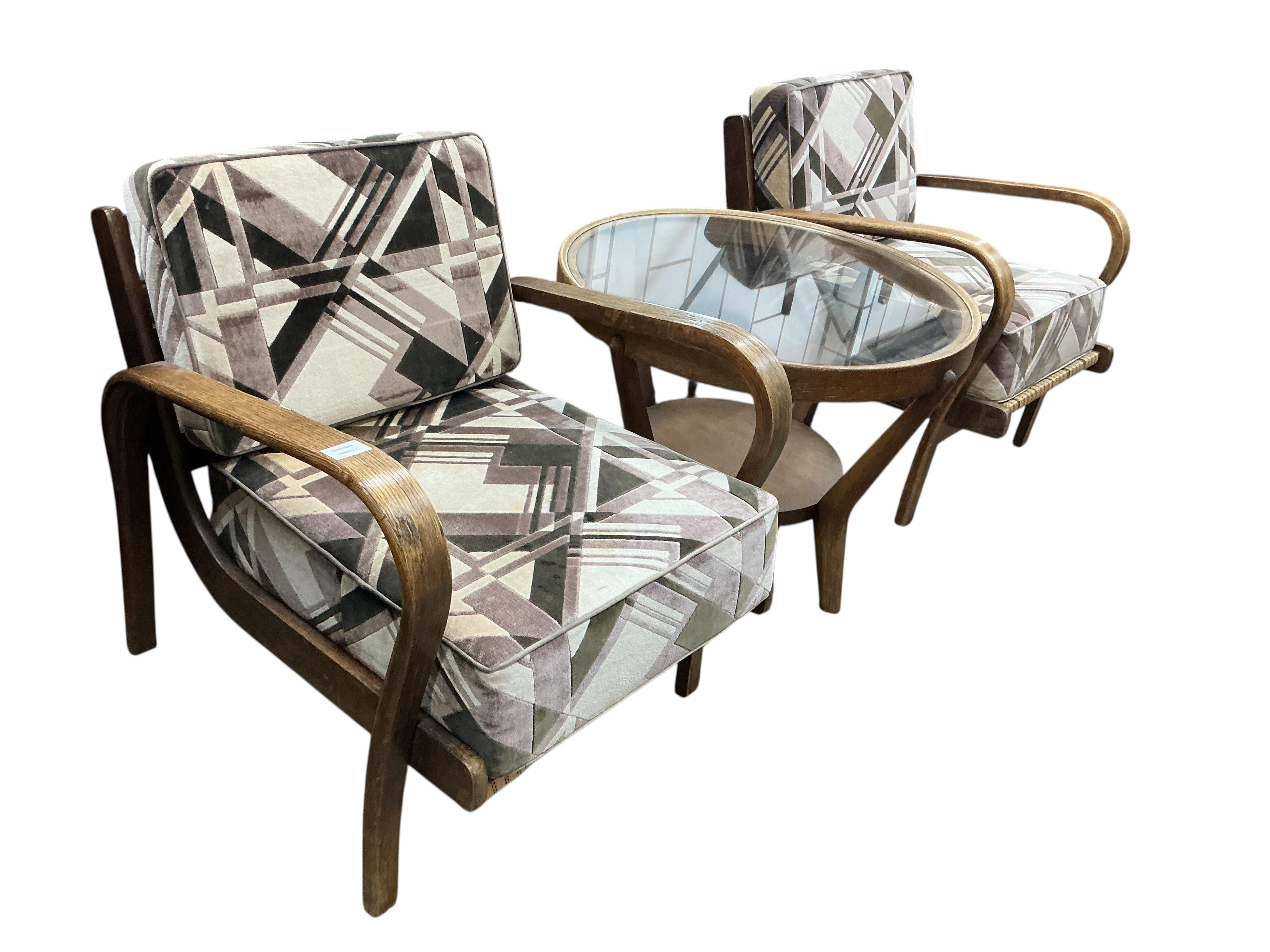 A 1930’s Czech bentwood suite comprising a pair of armchairs and circular low table, diameter 74cm, height 56cm.
